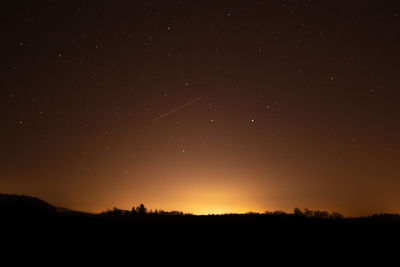 Scenic view of silhouette landscape against sky at night