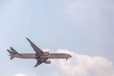 Low angle view of airplane flying against sky