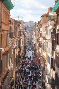 High angle view of people on street amidst buildings in city