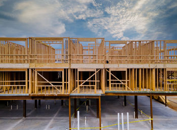 Construction site by bridge against sky