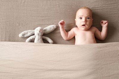 Portrait of baby girl lying on floor