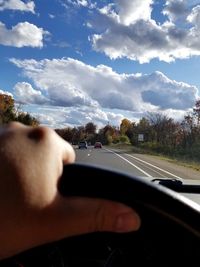 Cropped image of car on road against sky