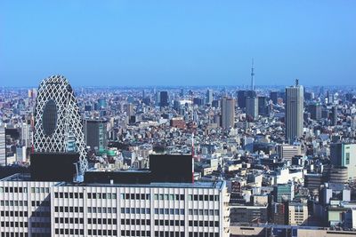 Cityscape against clear blue sky