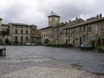 Street amidst buildings in city against sky