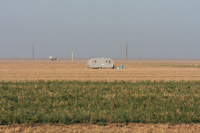 Scenic view of agricultural field against clear sky