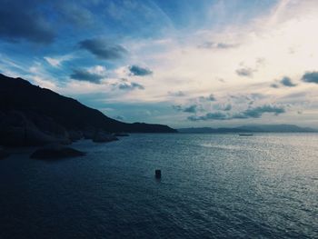 Scenic view of sea against cloudy sky