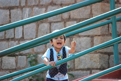 Portrait of smiling boy standing on steps