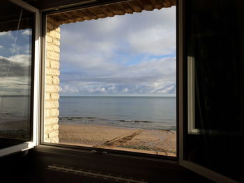 Scenic view of sea seen through window