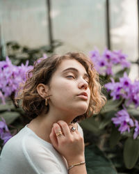 Close-up of young woman with purple flowers