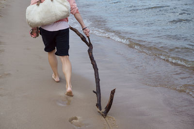 Rear view of people walking on beach