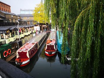 Boats moored on canal in city