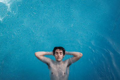 Portrait of a young man swimming in pool