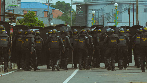 Police standing on street in city