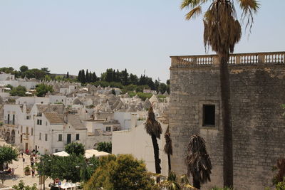 Trees and buildings against sky