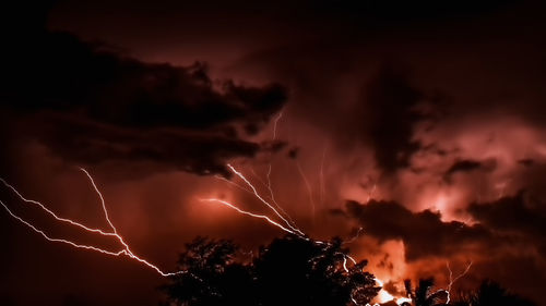 Low angle view of illuminated sky at night