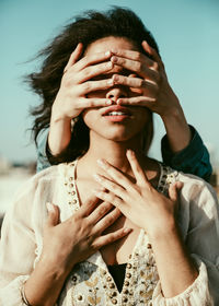 Close-up of woman hands covering friend face