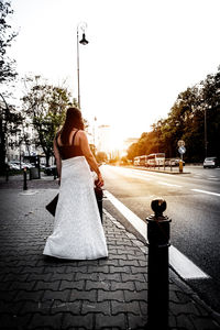 Rear view of woman on street in city