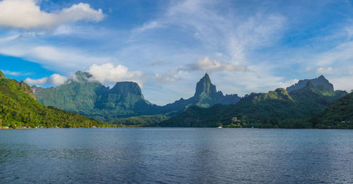 Scenic view of sea and mountains against sky