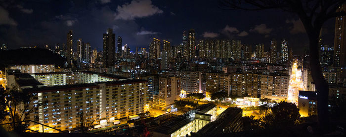 Illuminated cityscape against sky at night