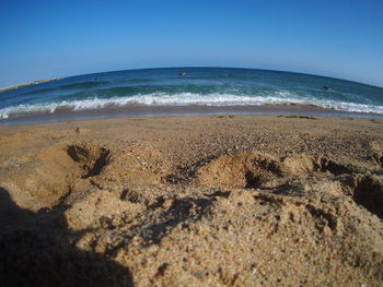 Scenic view of beach against clear sky