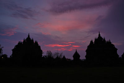 Silhouette of temple building against sky during sunset