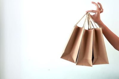 Woman holding umbrella against white background