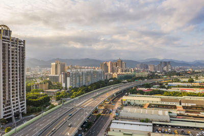 High angle view of street amidst buildings against sky