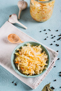 Homemade fermented cabbage in a bowl on the table vertical view