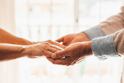 Cropped hand of man holding hands