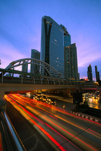 Buildings and bridge in city at dusk