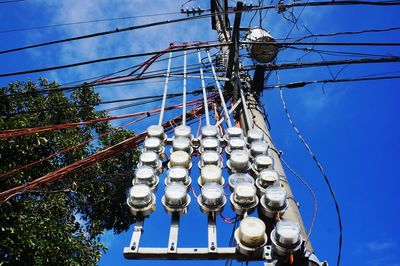 Low angle view of cables against blue sky