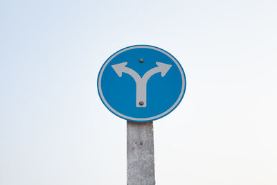 Close-up of road sign against clear sky
