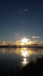 Scenic view of lake at sunset