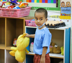 Portrait of a smiling boy with toy