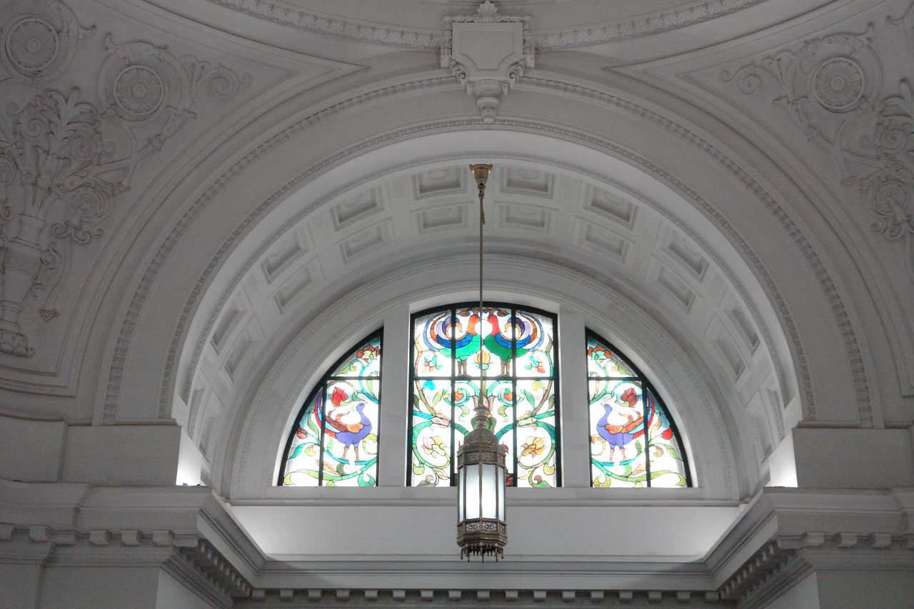 indoors, religion, place of worship, architecture, arch, church, spirituality, built structure, art and craft, art, low angle view, ornate, creativity, design, ceiling, human representation, stained glass, cathedral