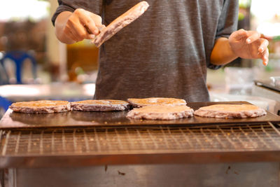 Midsection of man preparing food