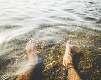 Low section of man in sea