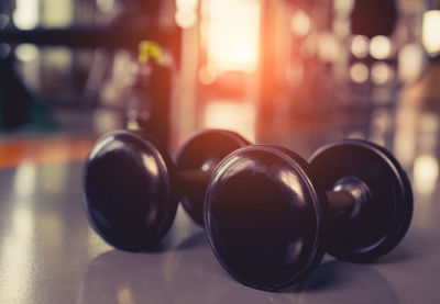 Close-up of dumbbells on floor at gym