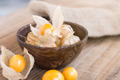 Close-up of food and flowers in bowl on table