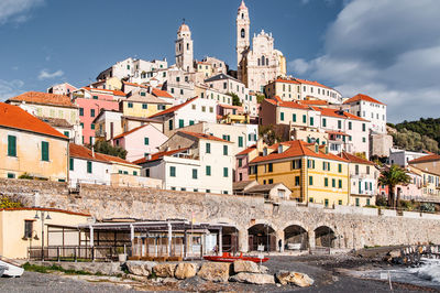 Buildings in town against sky