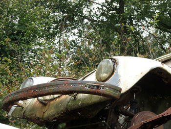 Abandoned vintage car on field