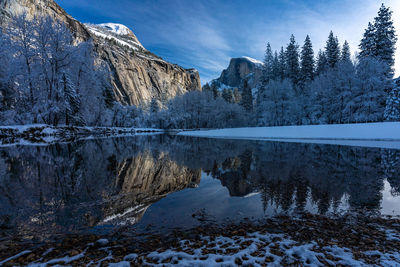 Scenic view of lake against sky during winter