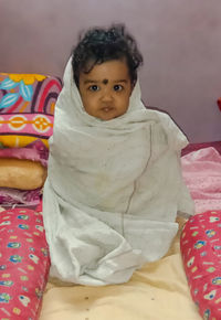 Portrait of cute girl relaxing on bed at home