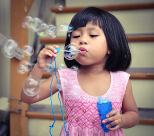 Girl blowing soap bubbles