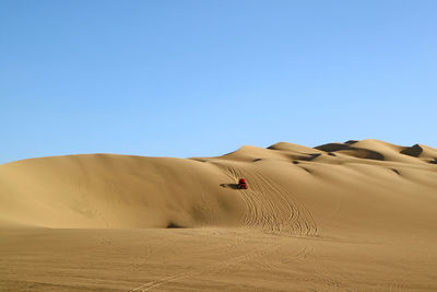 Scenic view of desert against clear sky