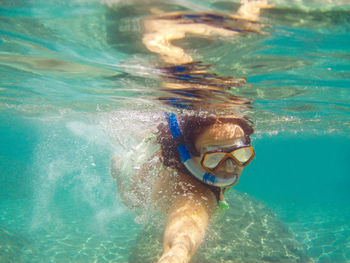 Portrait of young woman snorkeling in sea