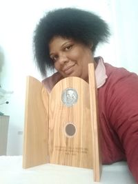 Portrait of smiling woman holding glass at home