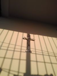 Close-up of cross against the wall