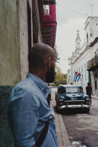 Man standing on street in city