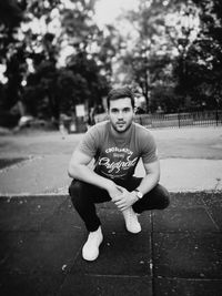 Portrait of young man sitting in city
